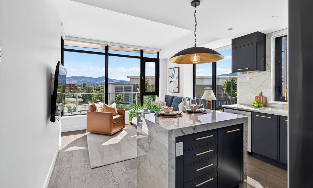 South Pandosy Condo | Luxury 2BR waterfront condo at AQUA Kelowna with a king suite, queen bedroom, private BBQ patio, high end designer interiors, quartz counters, custom navy cabinetry, premium appliances & steps from Okanagan Lake.