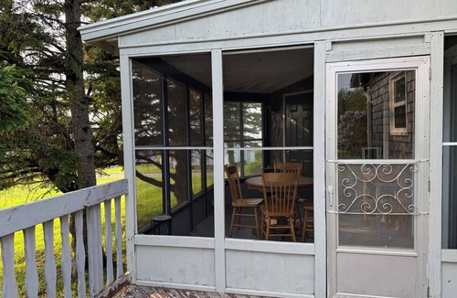 Cap-Pele Ski Chalet | A cottage among the trees, a cape, a beach.