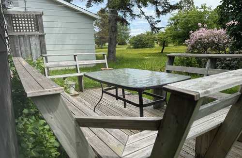Cap-Pele Ski Chalet | A cottage among the trees, a cape, a beach.