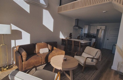 Riverport Cabin | A sanctuary of architectural restraint, unmediated coastal observation, and premium electric travel infrastructure.
