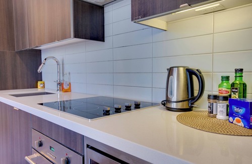Wellington Place Apartment | Beautiful Condo with Gym, Rooftop Pool + Private Patio!