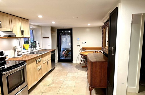 Grandview-Woodland House | Cozy Garden level suite with heated floors. 1 block off “The Drive”.