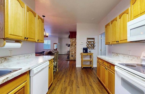 Sylva House | Mountain view home with a fireplace with beautiful view of the creek