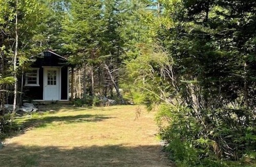 Liscomb Cabin | One Room Cabin with a double bed and small table with two chairs