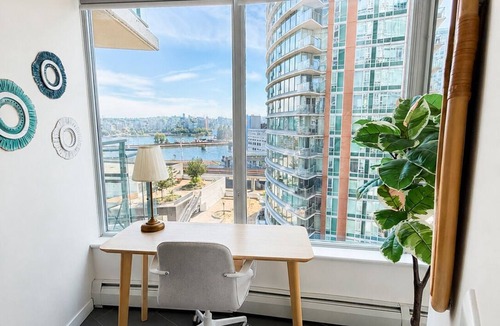 Gastown Apartment | Panoramic floor-to-ceiling windows with water views