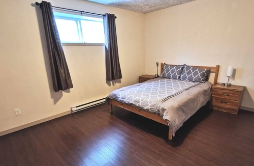 Saanich West House | Private 2 Bedroom Suite with one bed and a crib
