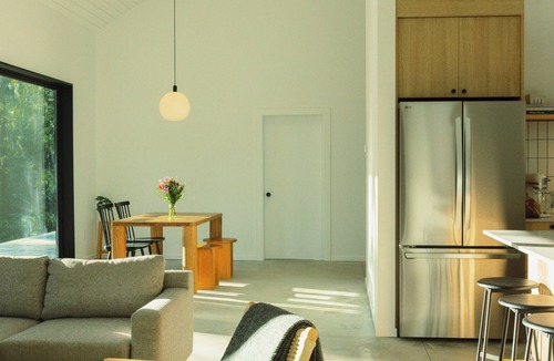 Garden Bay House | Scandinavian-inspired black cabin with cedar hot tub in a private forest.