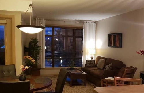 South Pandosy Condo | View of a courtyard with a pool and view of the mountains