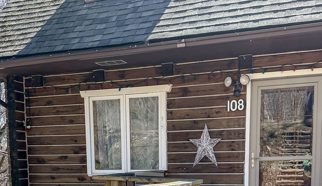 Cozy log cabin W/ Hot Tub, fire pit, trails nearby.
