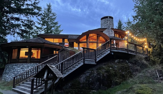 Island log home with expansive forest, lake and mountain views