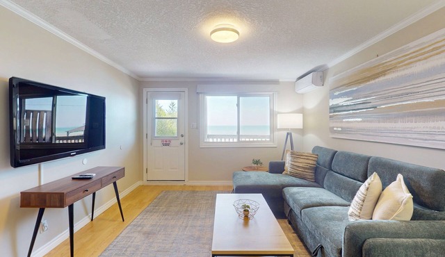 Lakefront condo steps to the beach with pool, and fireplace